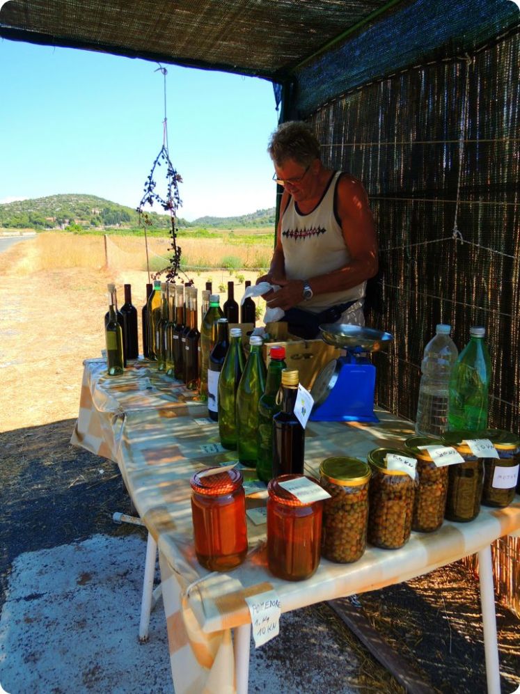 Man selling wine and other goods from his land